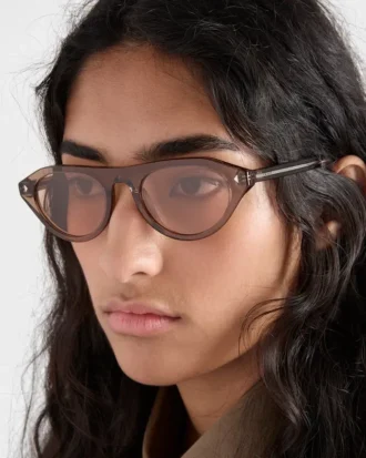 アイコニックなメタルプレートをあしらったPradaのサングラス